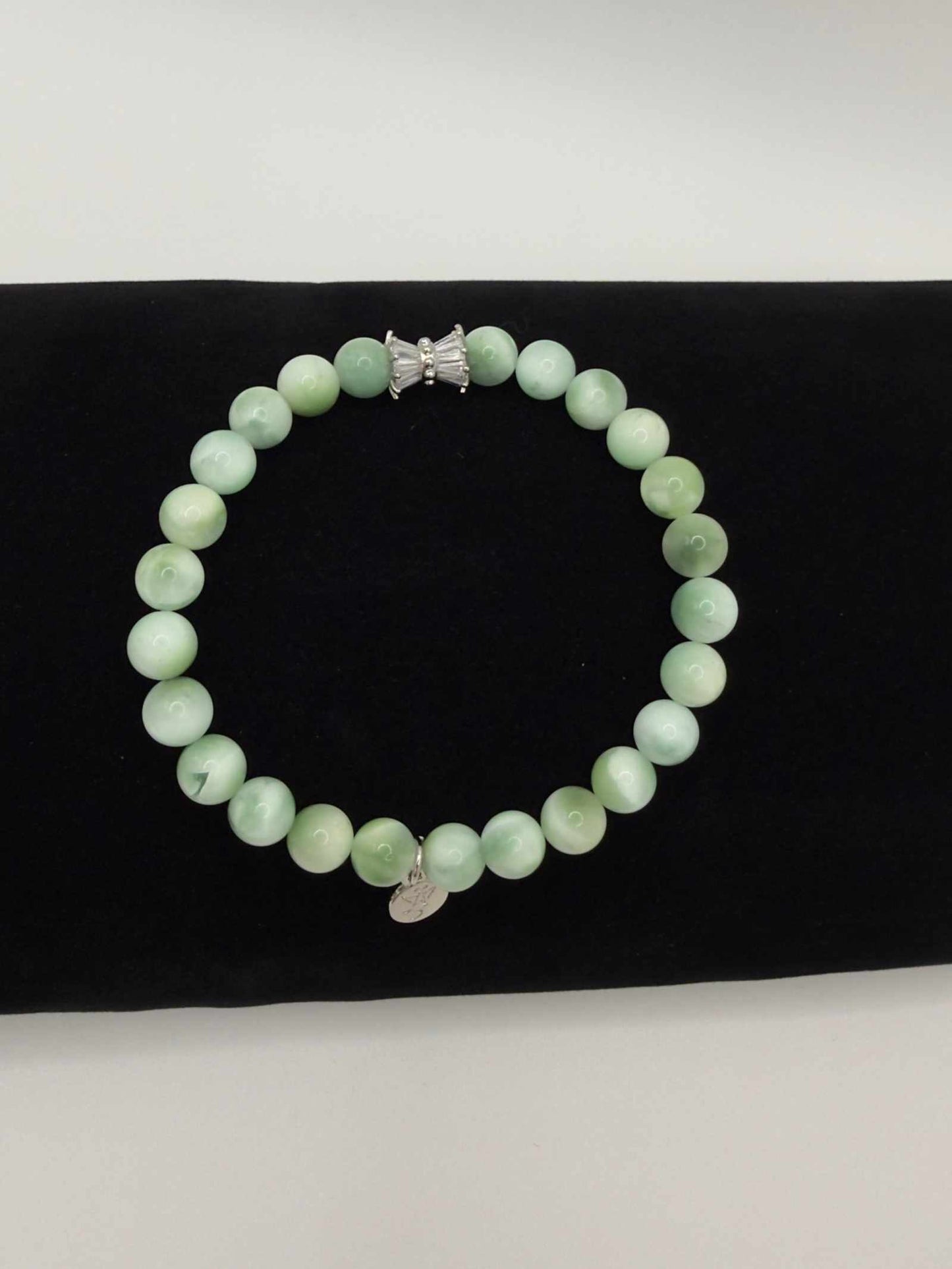 Seafoam Serenity Green Larimar Bracelet with polished green beads and elegant charm in soft ocean tones