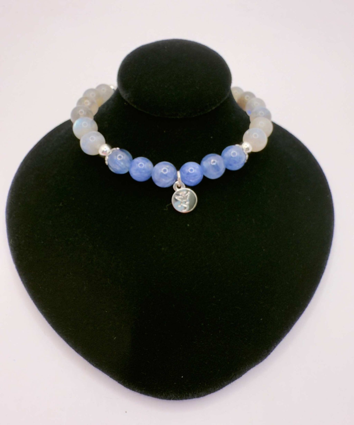 Awakening Light Bracelet with kyanite and labradorite beads on black display bust