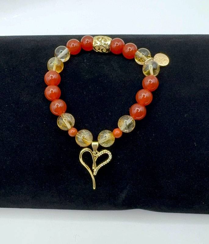 Passionate Love Bracelet with Carnelian, Citrine, Red Jasper, and gold heart charm on black background