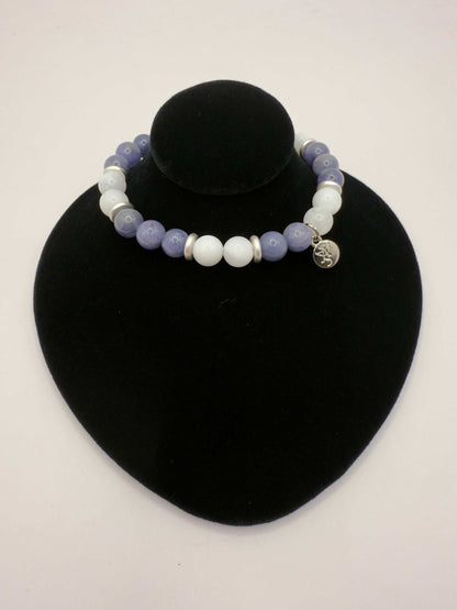 Moonlight Metamorphosis Bracelet with tanzanite and moonstone beads on black display stand