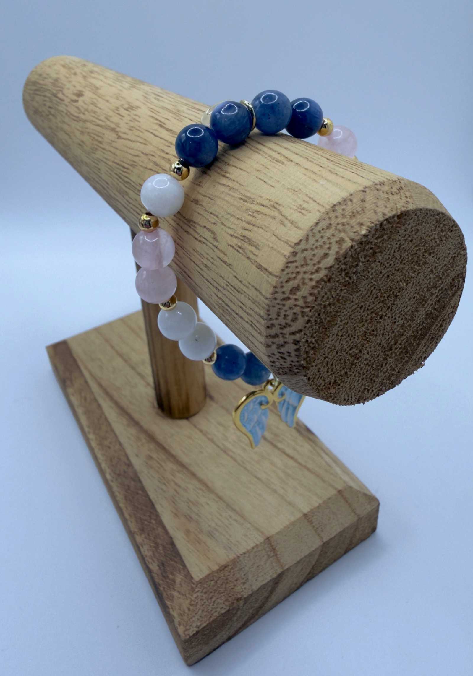 Handcrafted Blue Kyanite, Moonstone, and Rose Quartz grief bracelet with angel wings charm for emotional healing and comfort