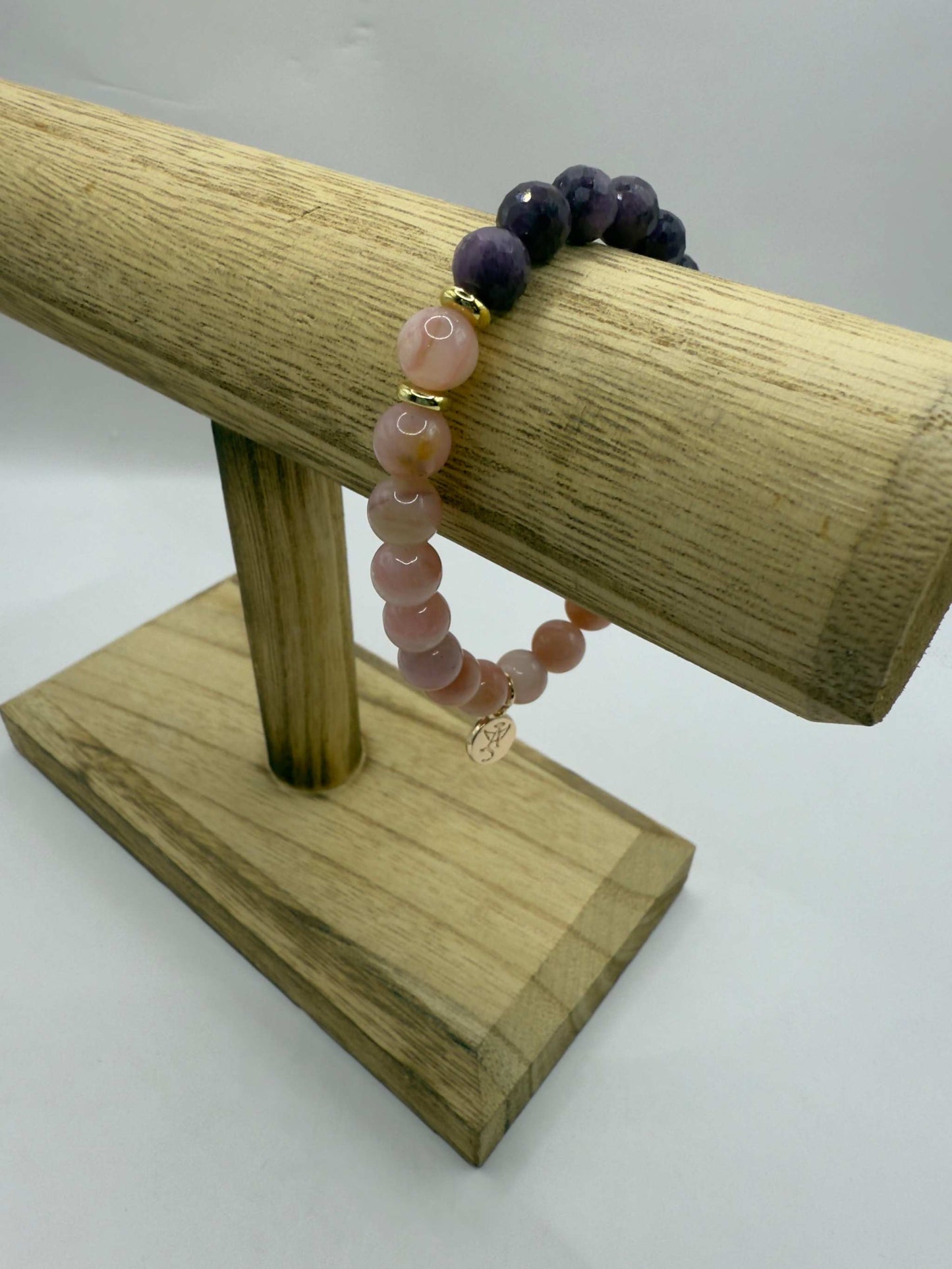 Wicked Bracelets Glinda edition pink opal and ruby gemstone stretch bracelet on wooden stand
