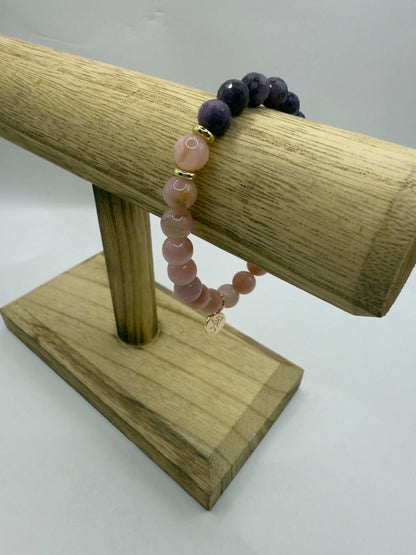 Wicked Bracelets Glinda edition pink opal and ruby gemstone stretch bracelet on wooden stand