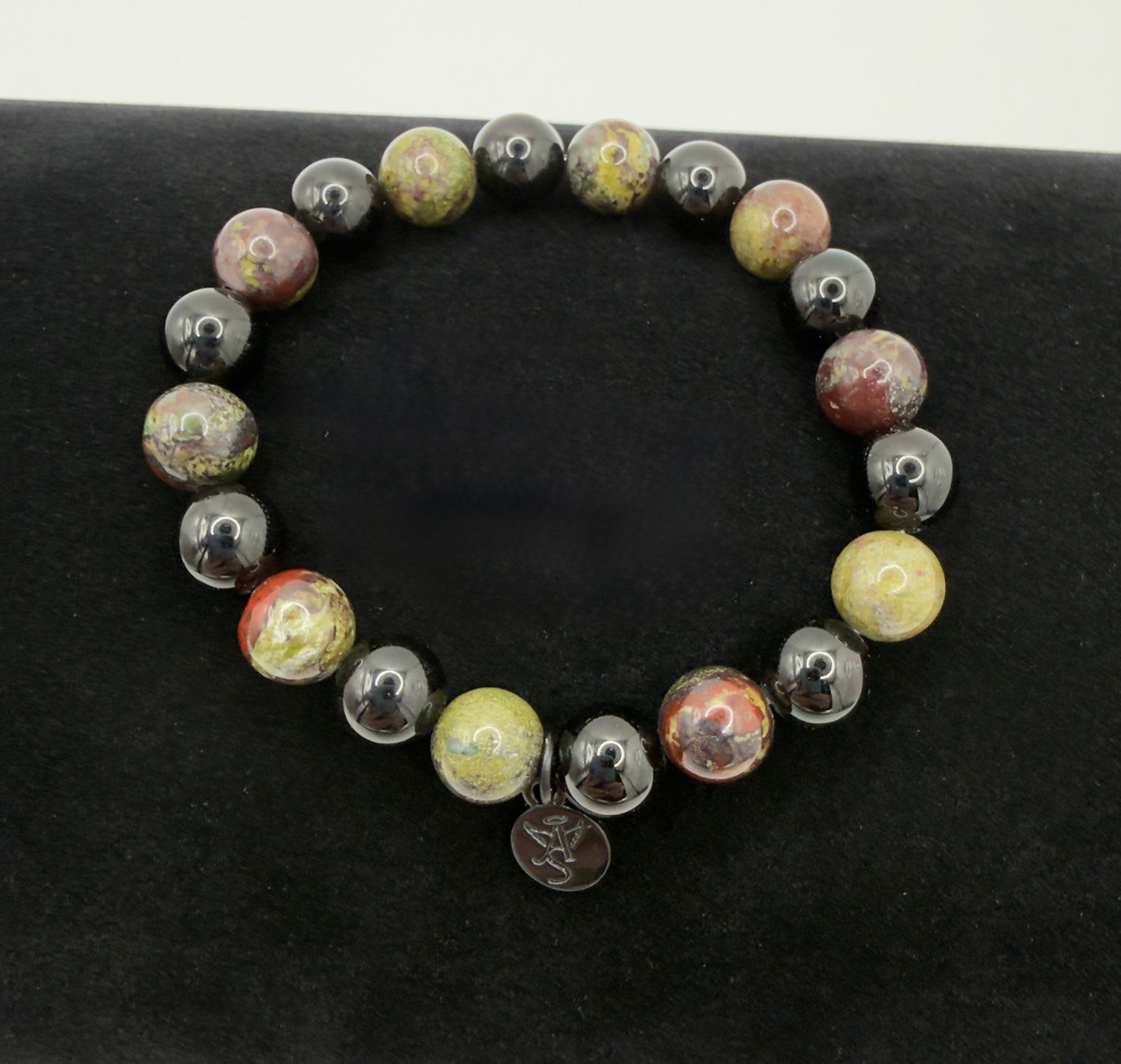 Black Tourmaline and Bloodstone protection bracelet with silver angel charm on a wrist