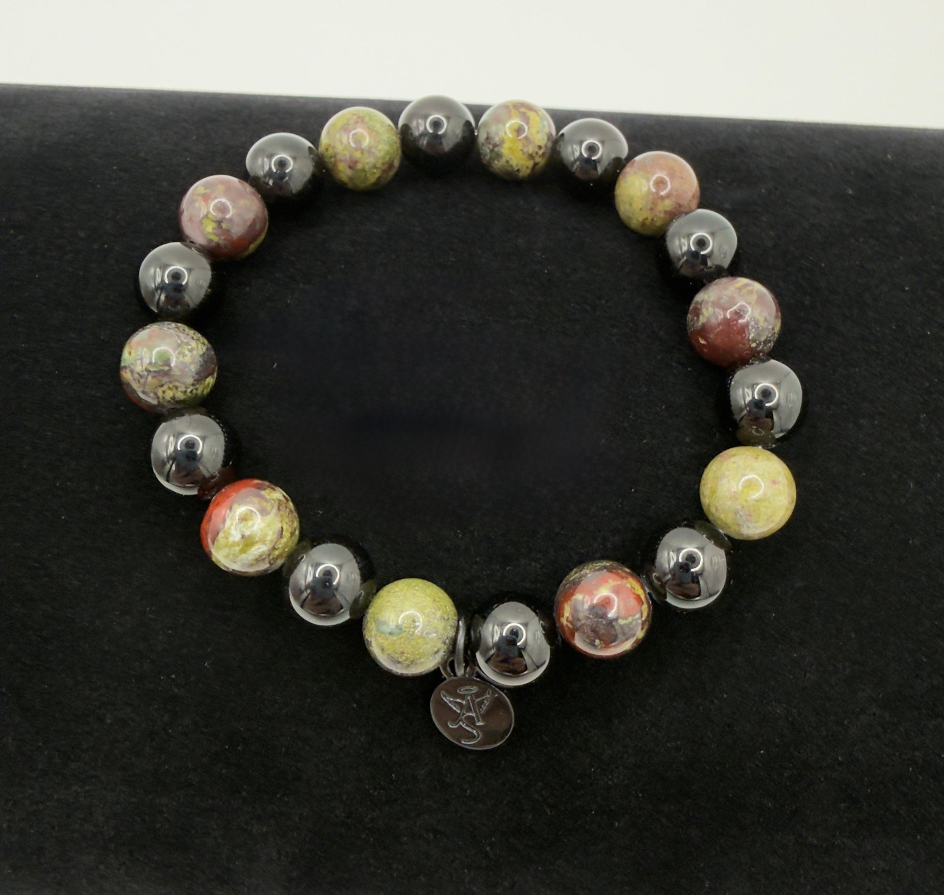 Black Tourmaline and Bloodstone protection bracelet with silver angel charm on a wrist