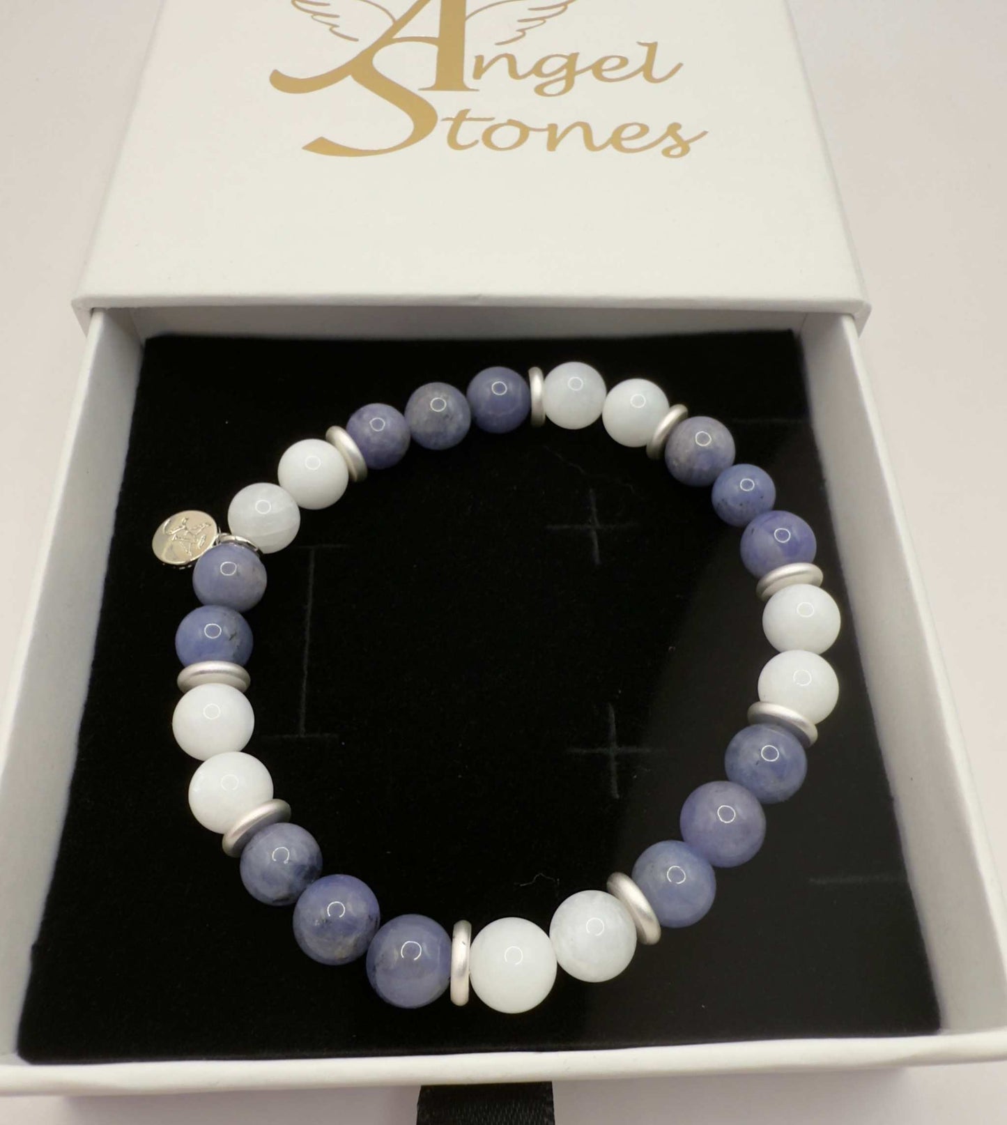 Moonlight Metamorphosis Bracelet with tanzanite and moonstone beads in a black jewelry box