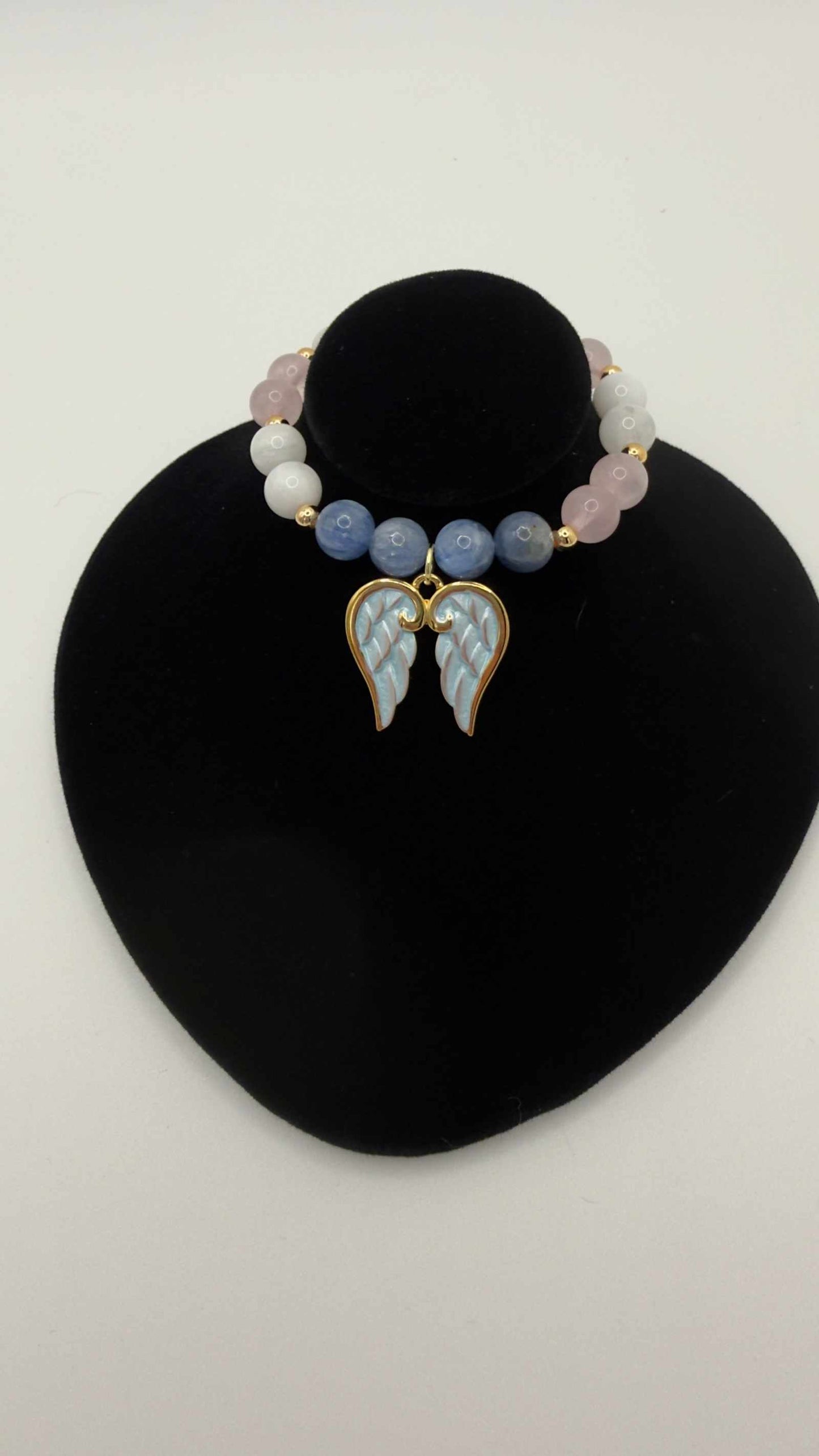 Blue kyanite, moonstone, and rose quartz grief bracelet with angel wings charm for emotional healing