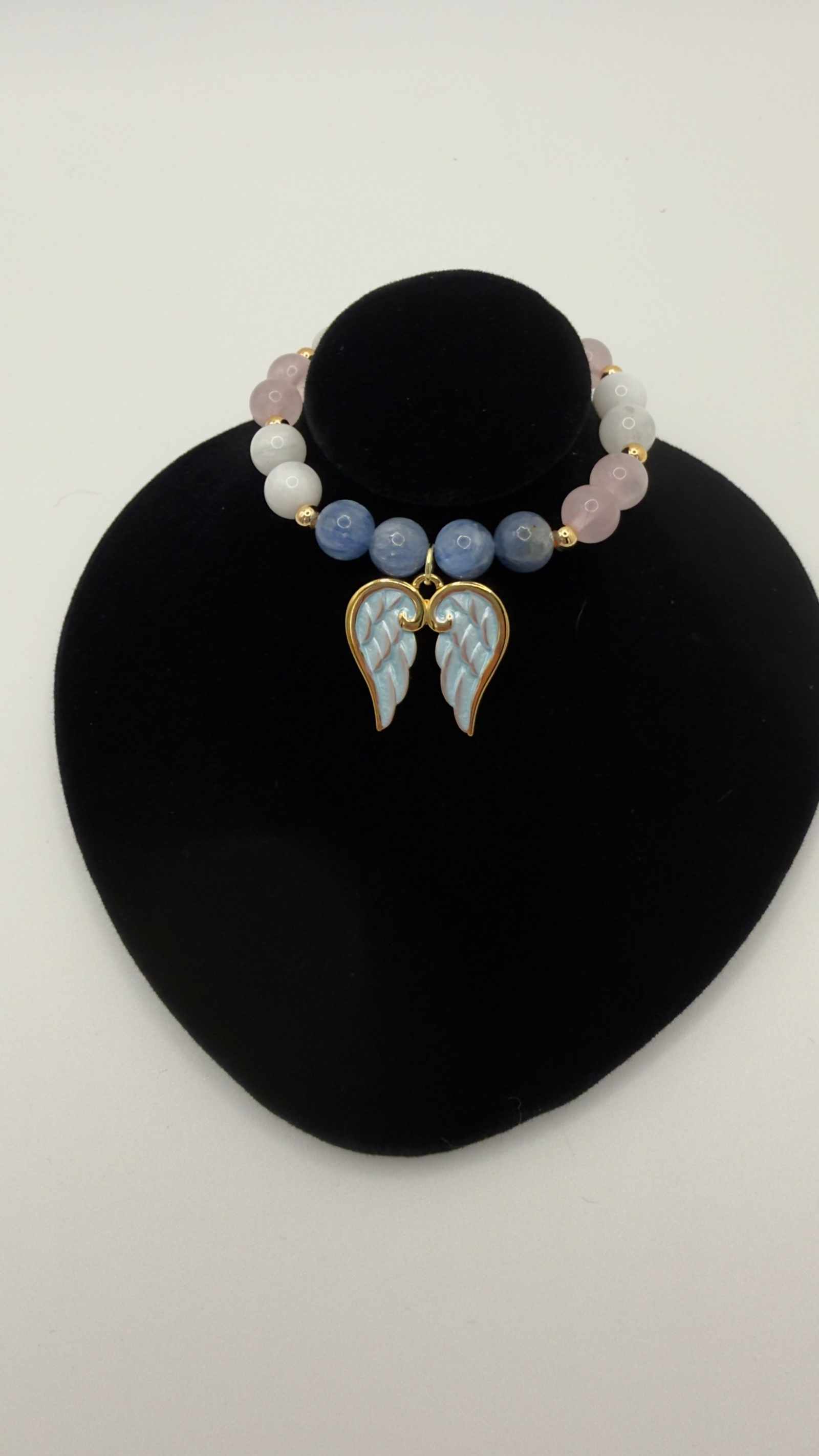 Blue kyanite, moonstone, and rose quartz grief bracelet with angel wings charm for emotional healing