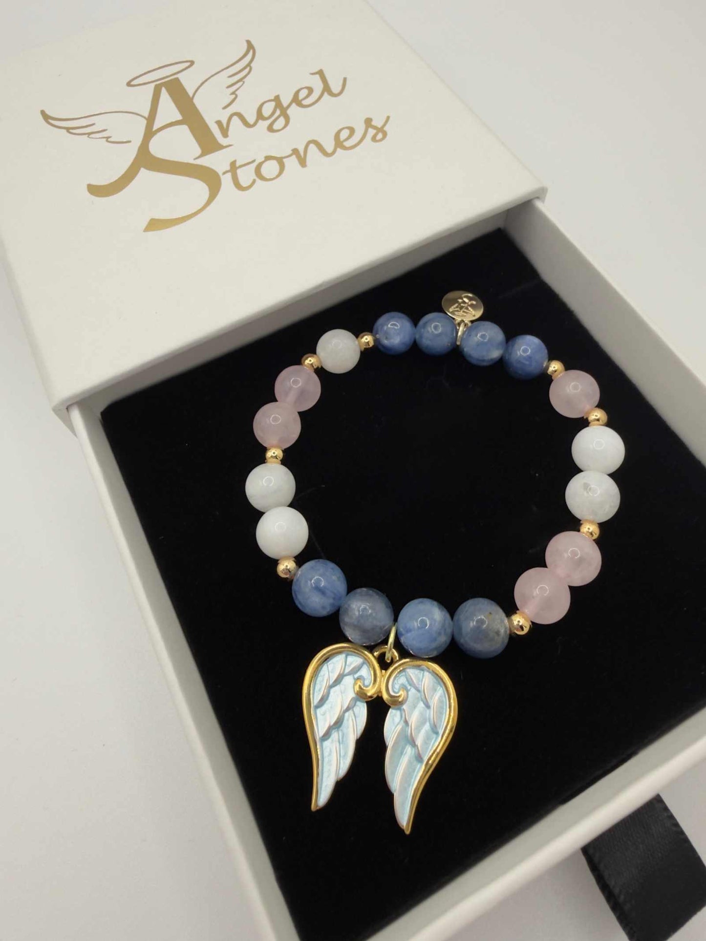 Blue kyanite, moonstone, and rose quartz grief bracelet with angel wings charm for emotional healing and support