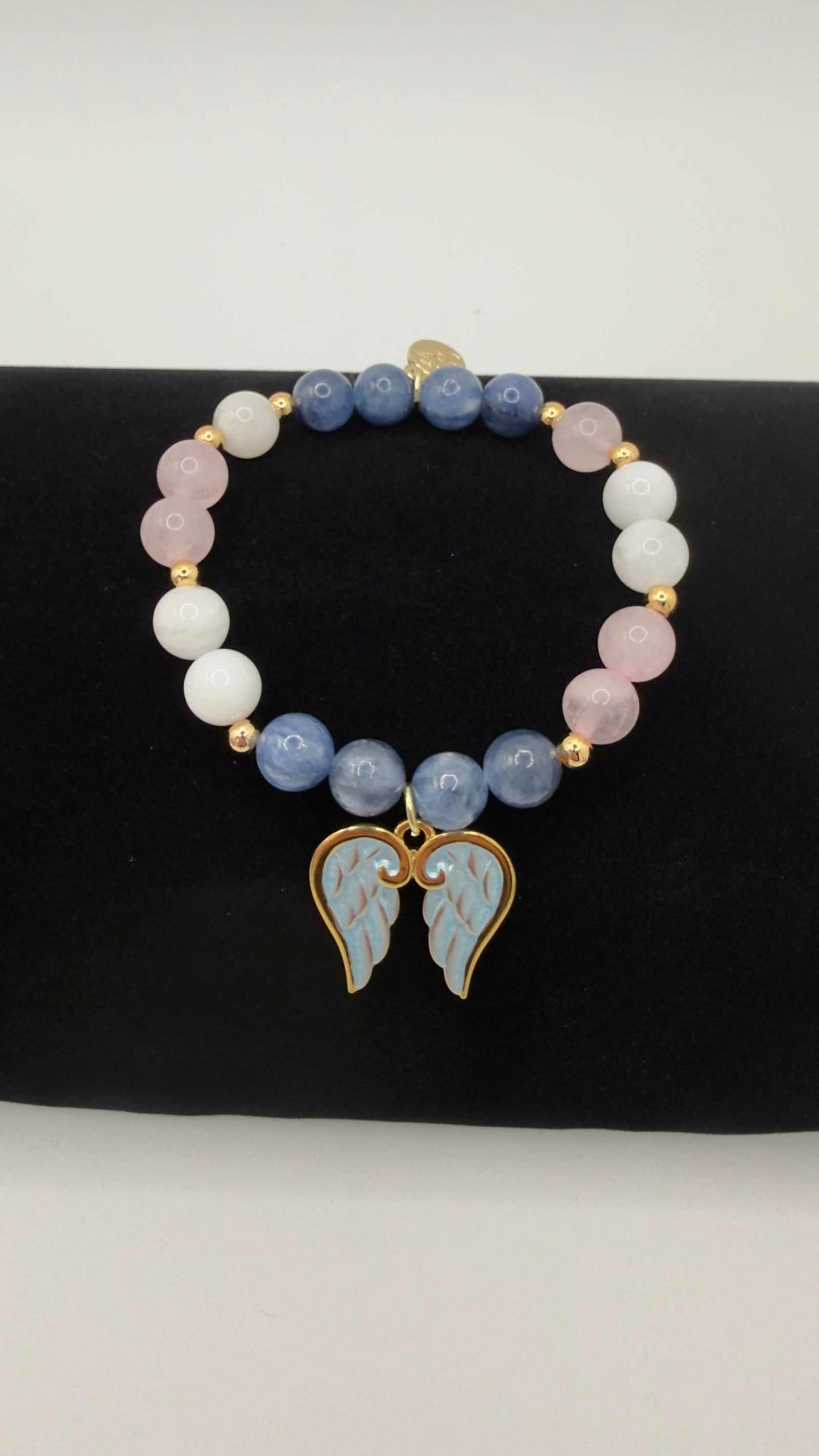 Handcrafted blue kyanite, moonstone, and rose quartz grief bracelet with optional angel wings charm for emotional healing and support