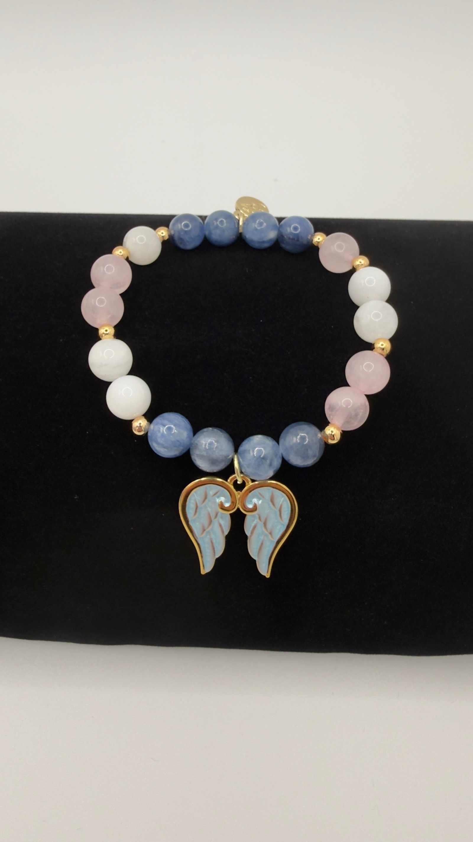 Handcrafted blue kyanite, moonstone, and rose quartz grief bracelet with optional angel wings charm for emotional healing and support