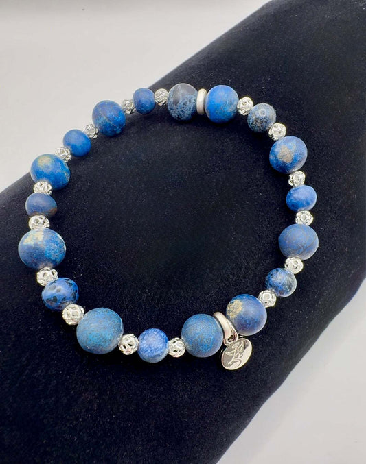 Blue Jean Daydreams bracelet with matte blue turquoise beads and sterling silver accents on black background