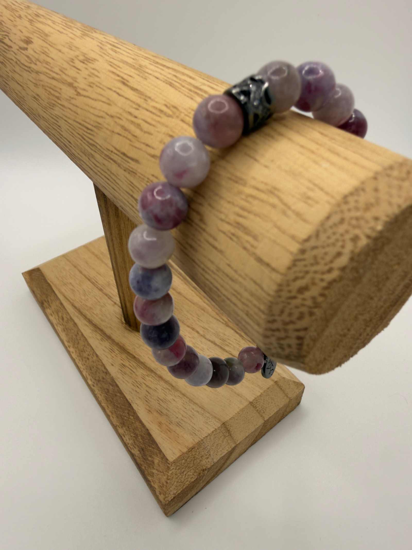 Mystic Harmony Unicorn Stone Bracelet with pink, purple, and earthy beads and elegant accent centerpiece
