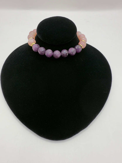 Limited edition Wicked Bracelets Glinda with pink opal and ruby gemstones on black display