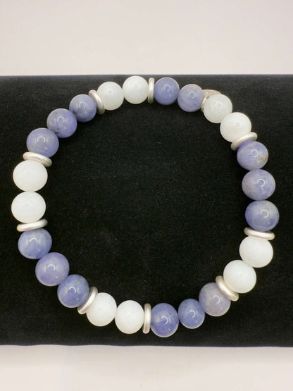 Moonlight Metamorphosis Bracelet with tanzanite and moonstone beads on a black background