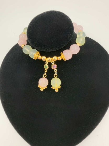 Close-up of Love in Bloom Bracelet with rose quartz and prehnite beads in soft pink and green tones