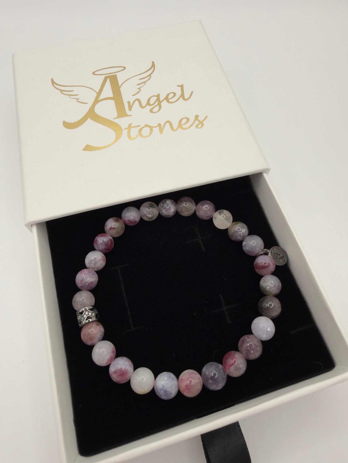 Mystic Harmony Unicorn Stone Bracelet with pink, purple, and earthy beads and elegant accent bead centerpiece