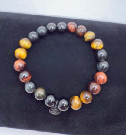 Superior Energy Protection Bracelet with black tourmaline and yellow, red, blue tiger eye beads on black background