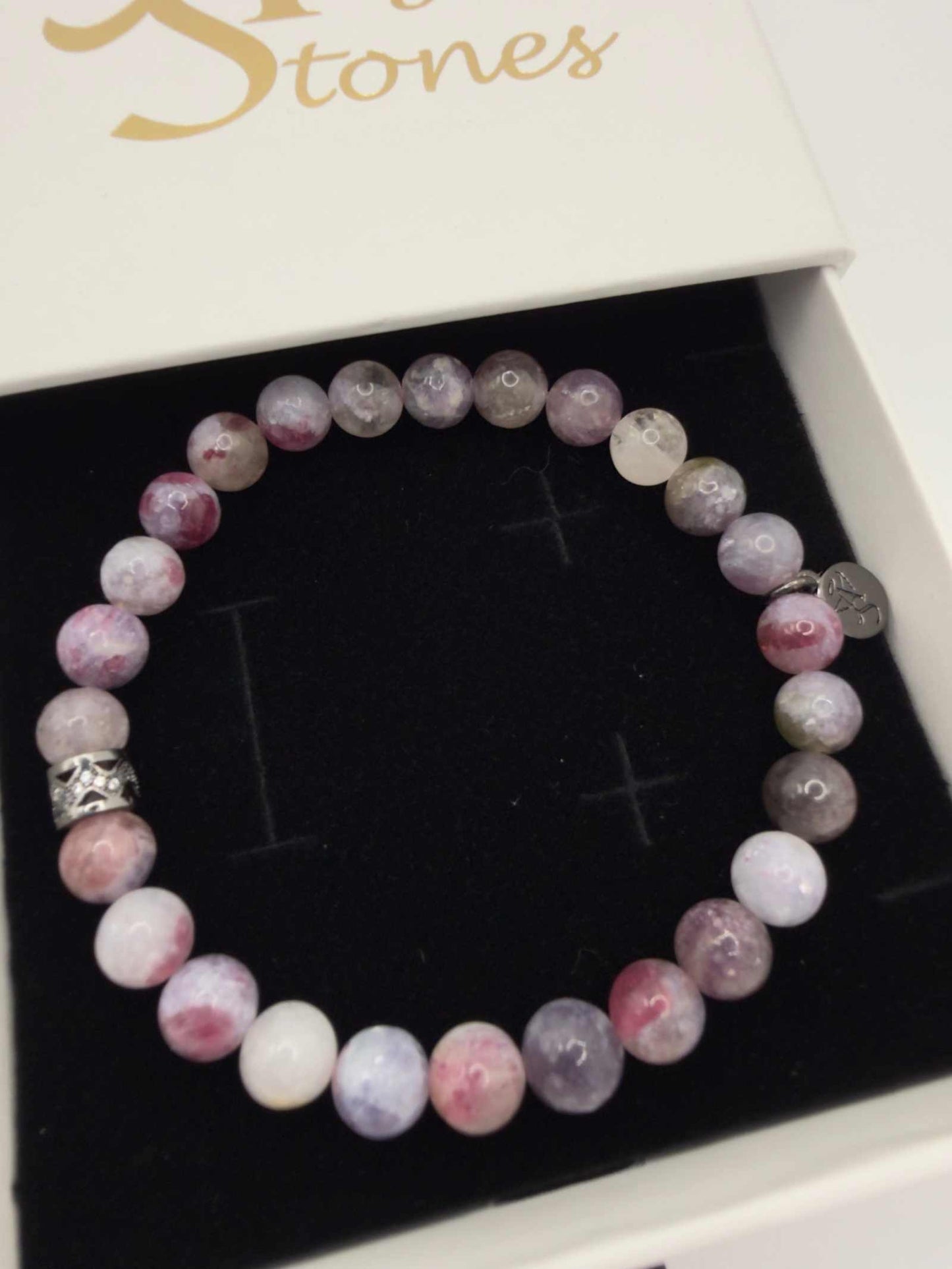 Mystic Harmony Unicorn Stone Bracelet with pink, purple, and earthy beads featuring an elegant accent bead