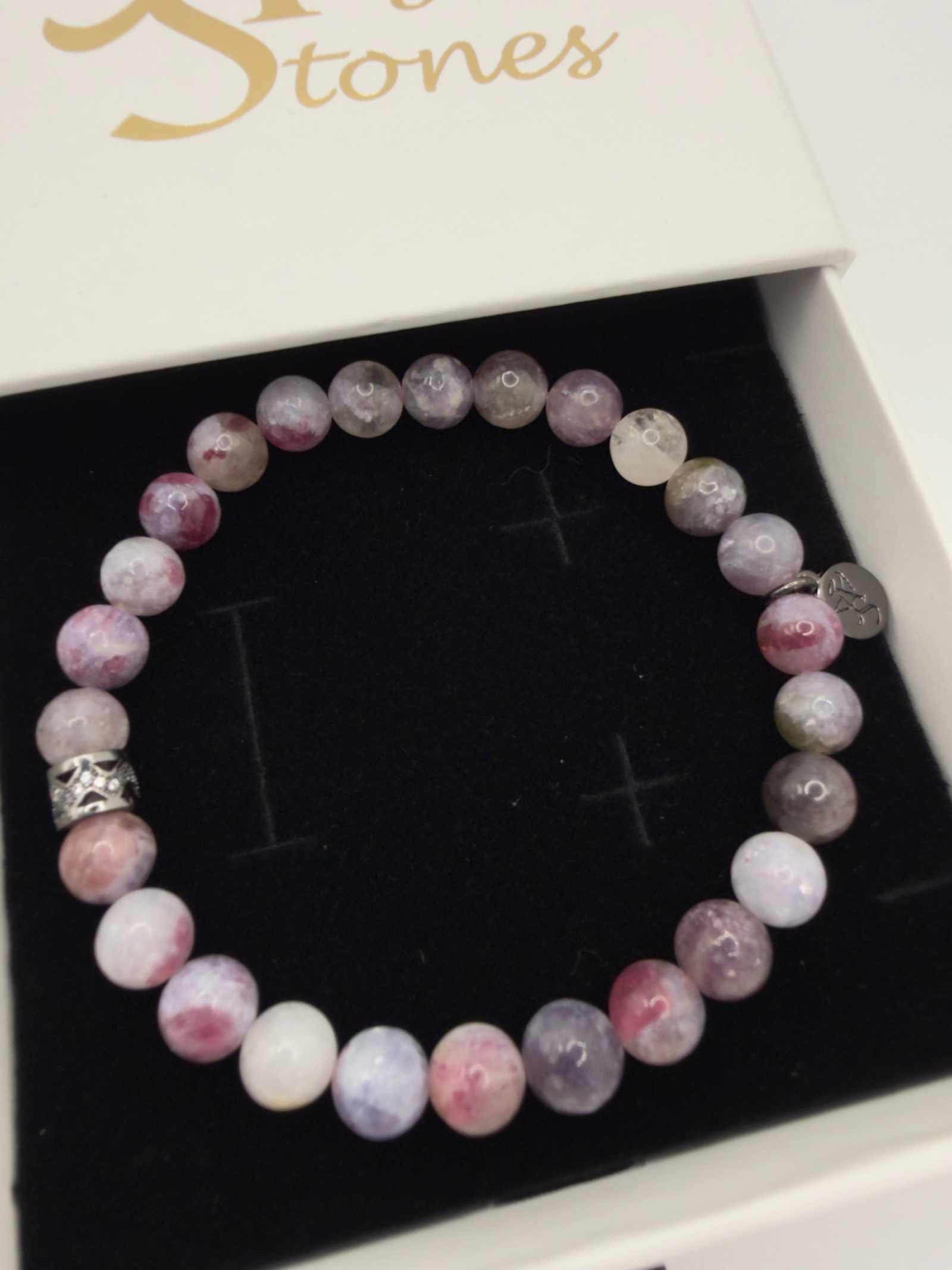 Mystic Harmony Unicorn Stone Bracelet with pink, purple, and earthy beads featuring an elegant accent bead
