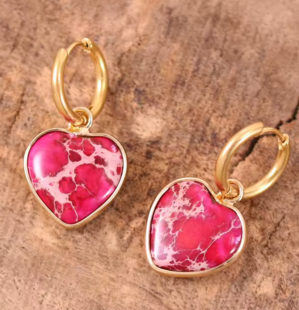 Gold-tone jasper huggie earrings with scarlet red heart-shaped jasper stones featuring natural veining