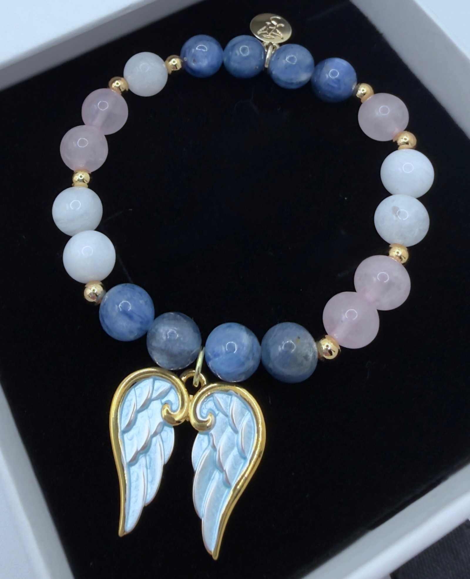 Handcrafted blue kyanite, moonstone, and rose quartz grief bracelet with optional angel wings charm for emotional healing and support