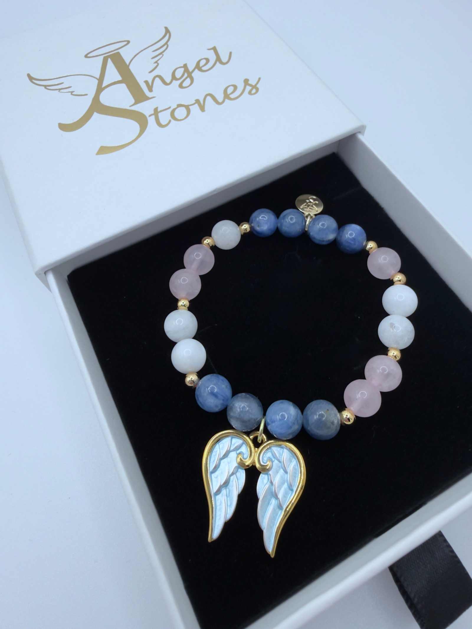 Handcrafted grief bracelet with blue kyanite, moonstone, and rose quartz beads on stretch cord
