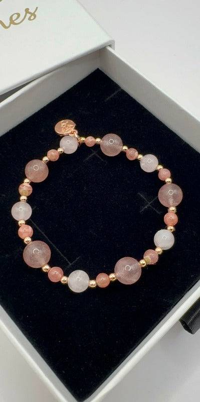 Love Harmony Bracelet with strawberry quartz, rose quartz, rhodochrosite, and rose gold accents in a black gift box