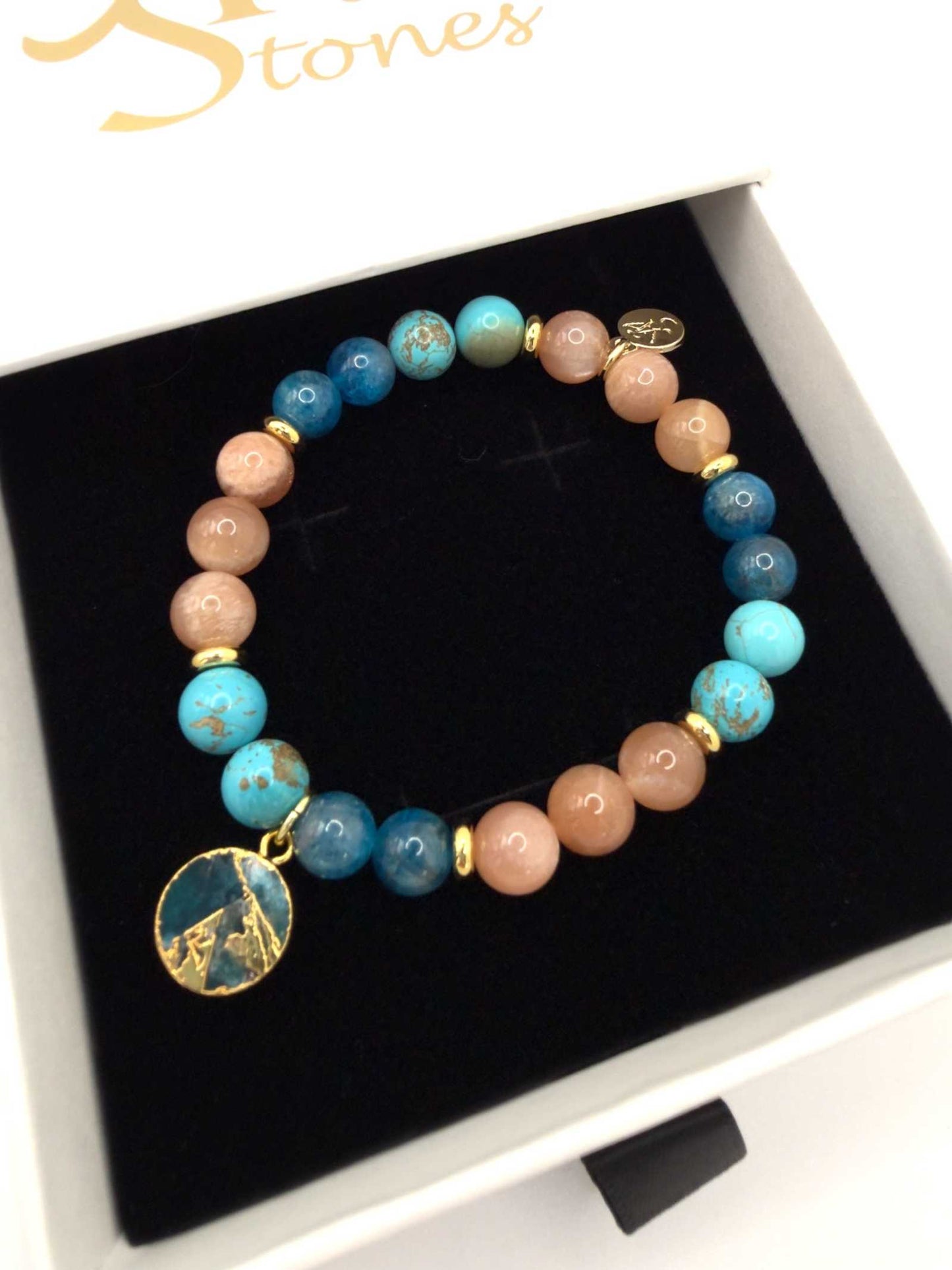 Ocean of Possibilities Bracelet featuring 8mm apatite, sunstone, and turquoise gemstones on a stretch cord with optional charm
