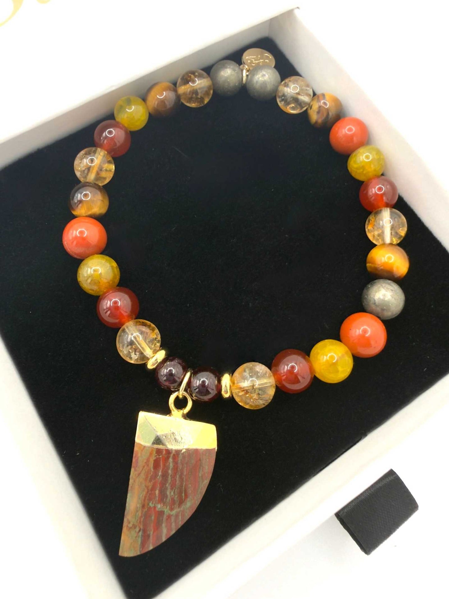 The Warrior Bracelet featuring Citrine, Garnet, Carnelian, Red Jasper, Tiger Eye, Fire Agate, Pyrite, and optional Jasper tusk charm.