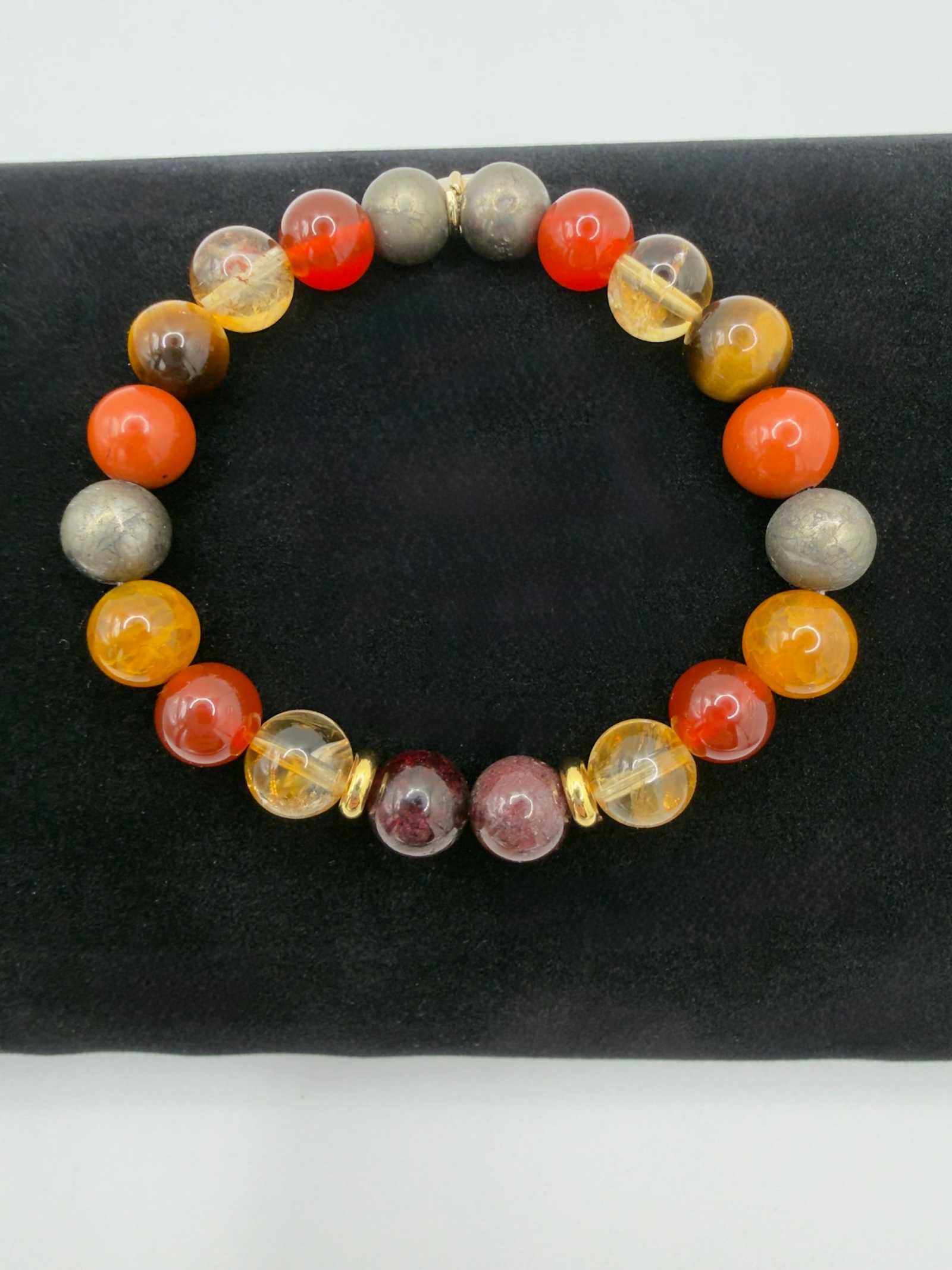 The Warrior Bracelet featuring Citrine, Garnet, Carnelian, Red Jasper, Tiger Eye, Fire Agate, Pyrite, and optional Jasper tusk charm.