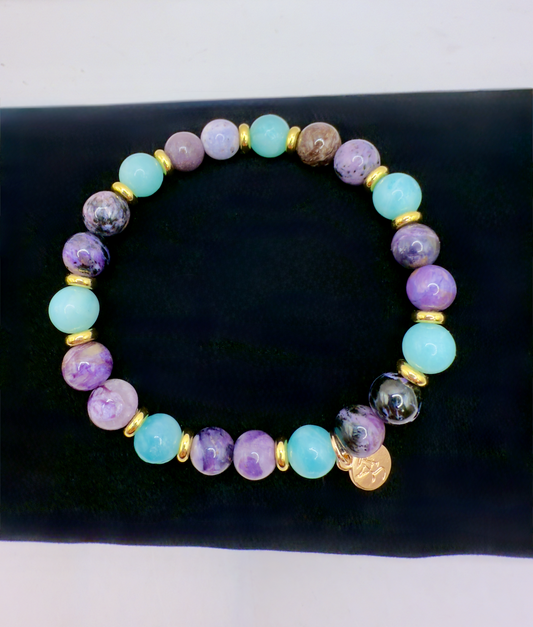 Transformation Bracelet with Amazonite, Charoite, and Sugilite beads and gold spacers on black background