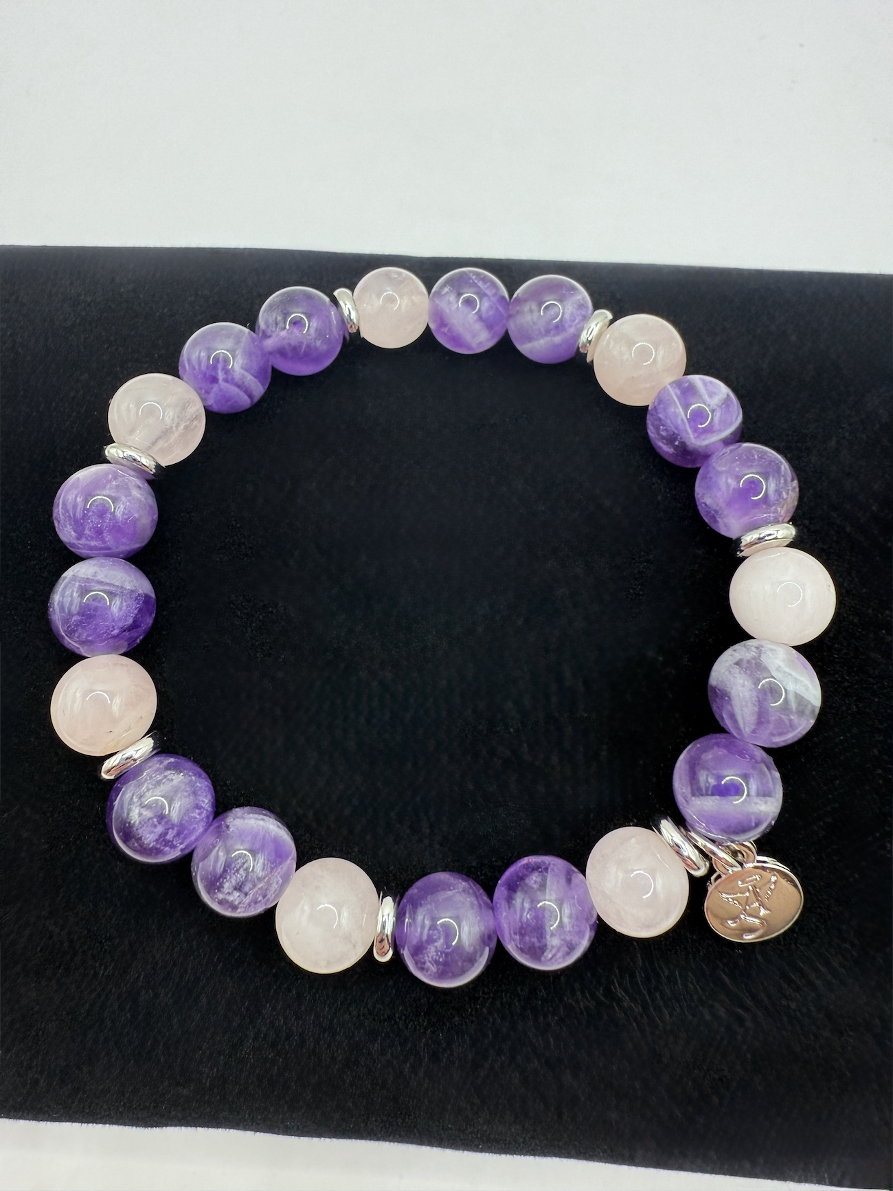 Harmony Bracelet with natural amethyst and rose quartz beads and Angel Stones logo charm on stretch cord