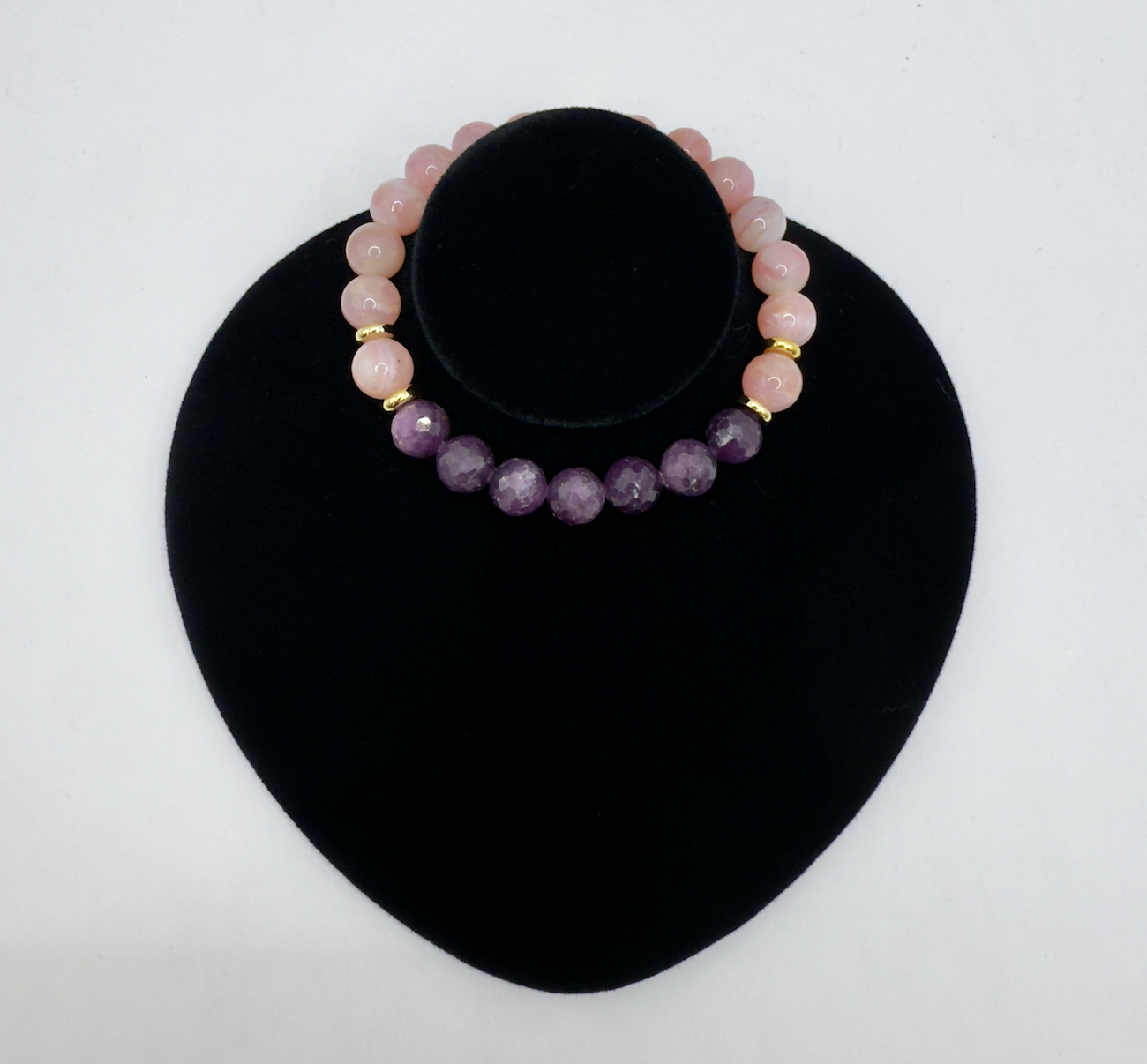 Pink opal and ruby gemstone Wicked Bracelets Glinda edition on black display stand