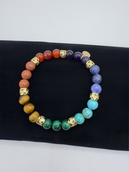 Colorful Chakra Bracelet with Dragon Fire Agate, Goldstone, Yellow Tiger Eye, Malachite, Turquoise, Sodalite, and Amethyst on black background