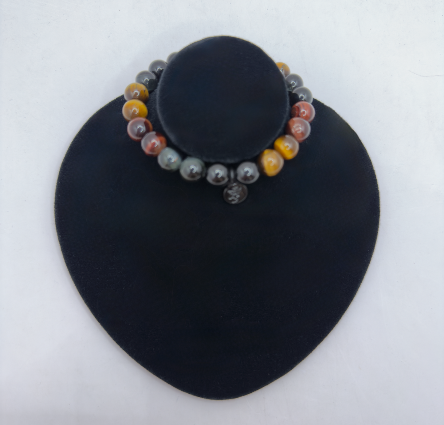 Superior Energy Protection Bracelet with Black Tourmaline and Yellow, Red, Blue Tiger Eye beads on black display stand