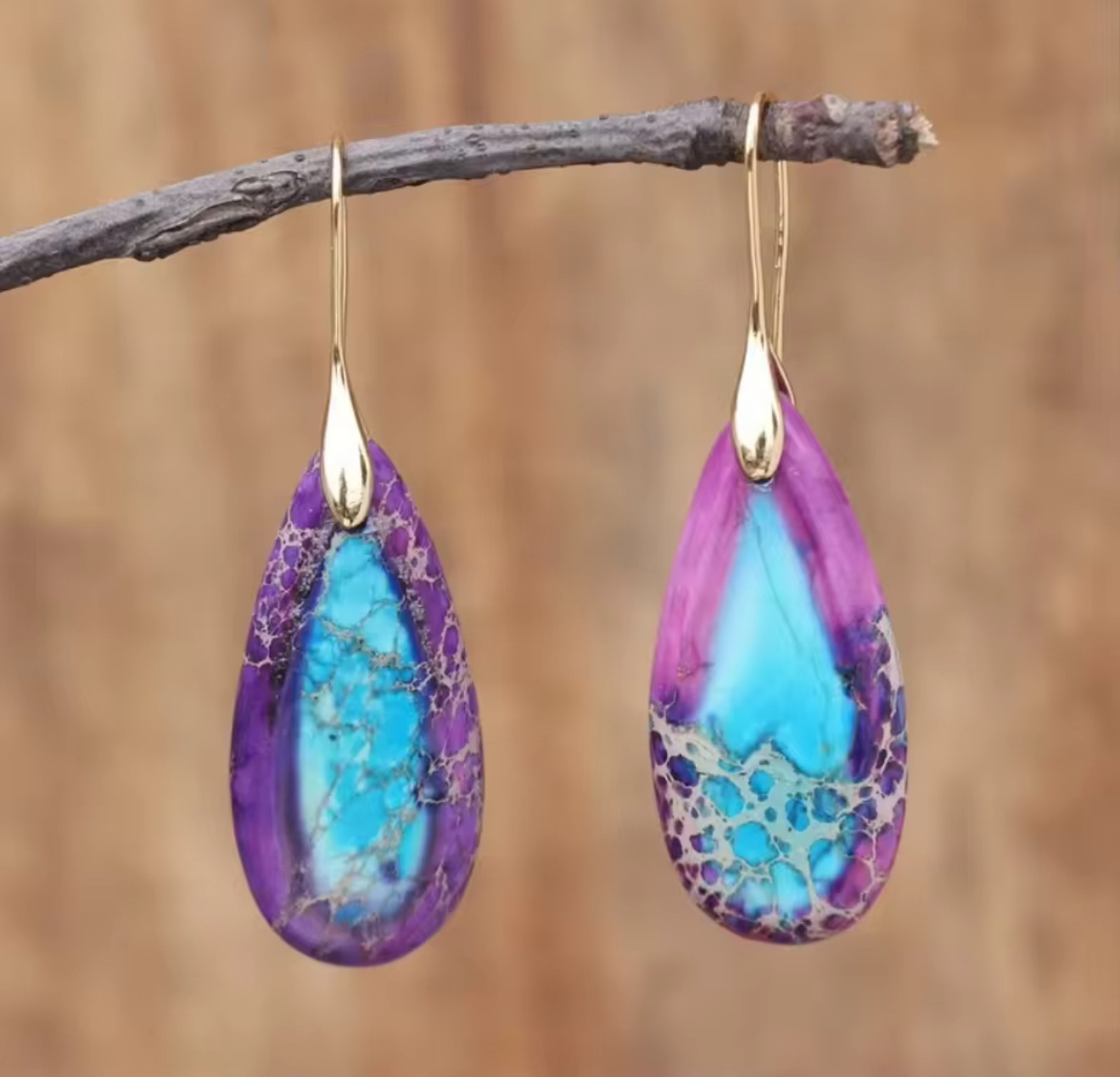Violet Tide Stone Drop Earrings with teardrop-shaped natural stones in bright violet and turquoise hues, set on gold-tone hooks.