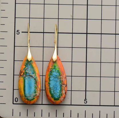 Sunfire Tide Jasper Drop Earrings with multicolored jasper teardrop stones and gold-tone hooks on measurement grid background
