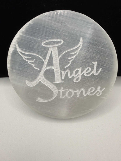 Selenite charging plate with engraved Angel Stones logo and luminous glow